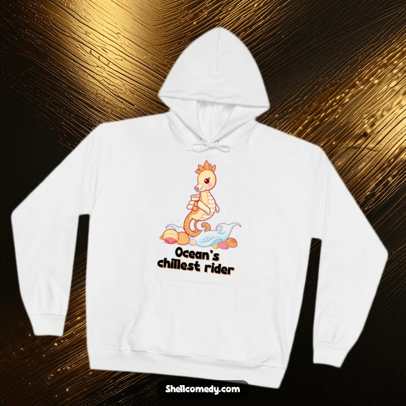 Funny Seahorse Hoodie: A grinning seahorse surfs a gentle wave, playfully approaching a dazzling collection of seashells.
