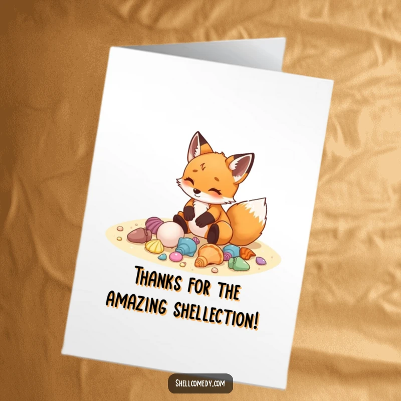 Free printable thank you card of a delighted fox cub arranging a collection of colorful seashells on the sand, offering thanks.